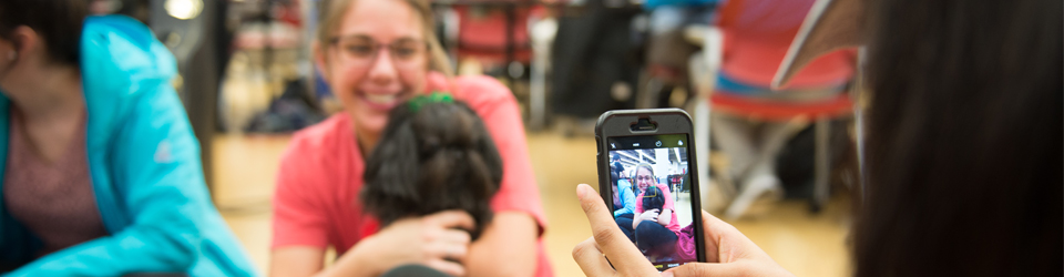 Student holding dog